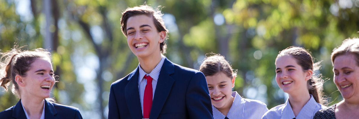 Three students and a principal smiling for a photo