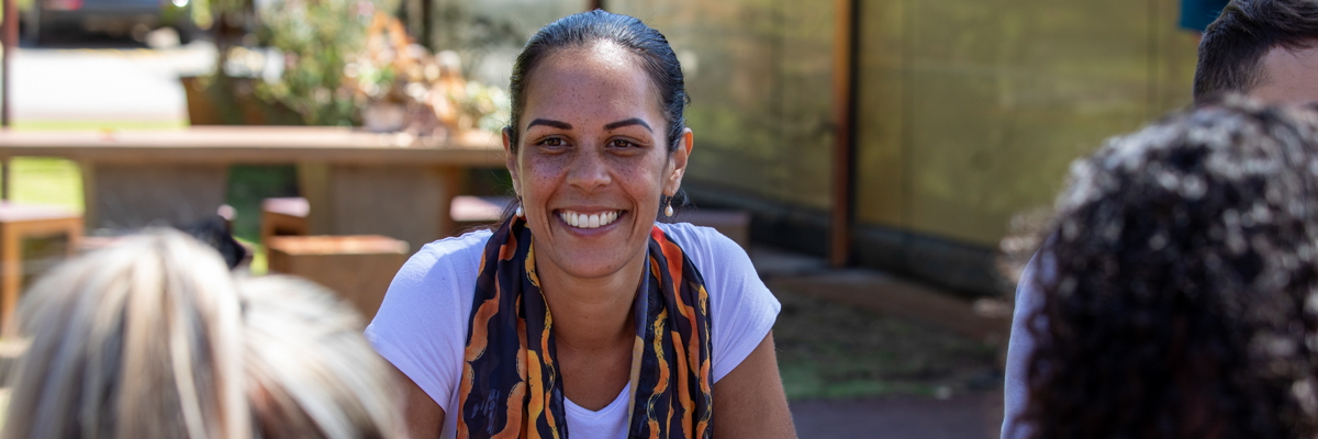A staff member enjoying converstation outdoors