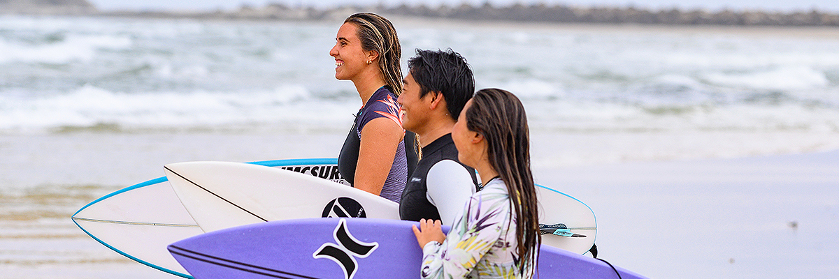 Surfing excellence students on the beach