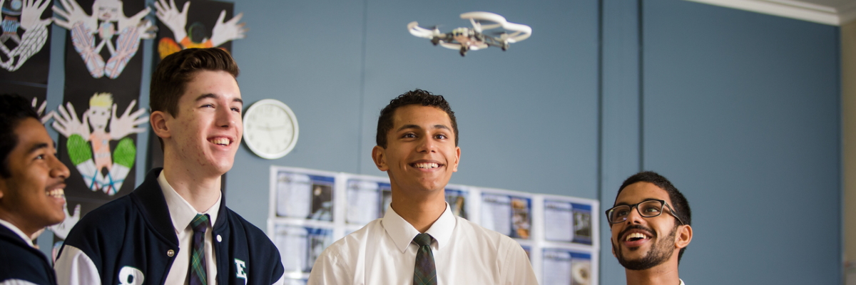 Engineering students using a small drone